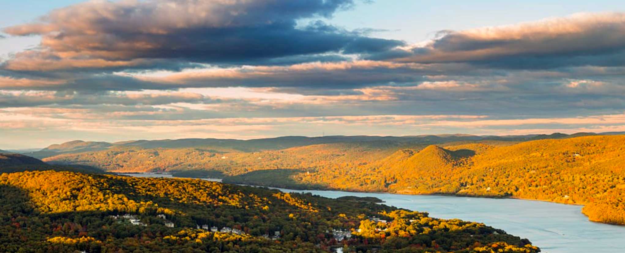 Scenic view of a river and shores with clouds above.