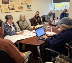 People seated at a table in discussion.